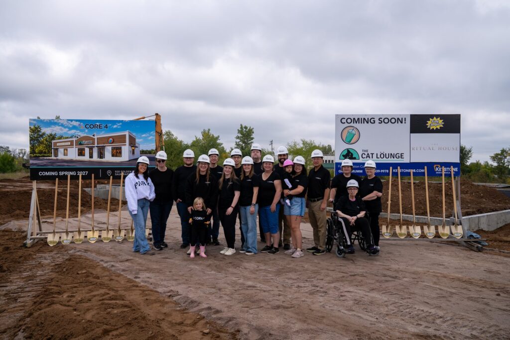 The full group at the Golden Spike Road groundbreaking, with the Cat Lounge coming soon sign