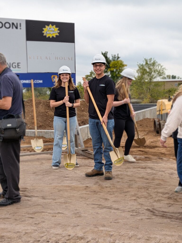 Josh and Isabel with gold shovels at the groundbreaking