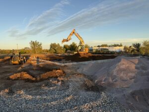Excavation underway at the Golden Spike Road site at dusk